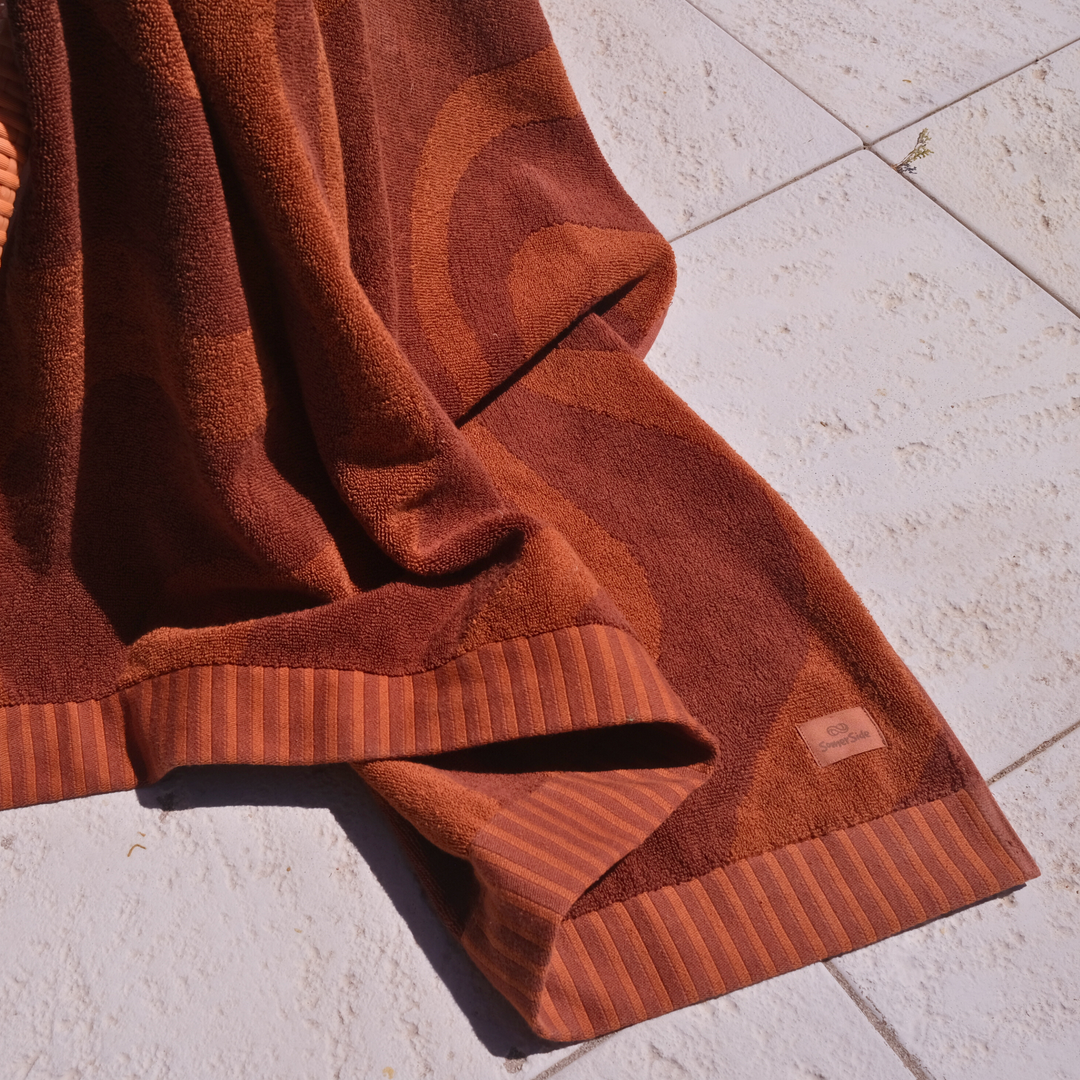 SomerSide Sundown 600 GSM cotton beach towel close-up showing rich amber jacquard texture and striped border